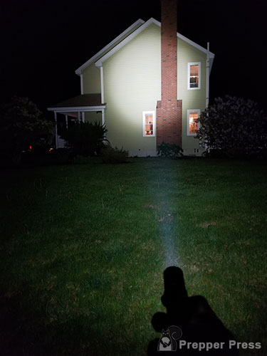 tactical flashlight against house