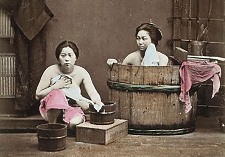two women bathing with a wash tub