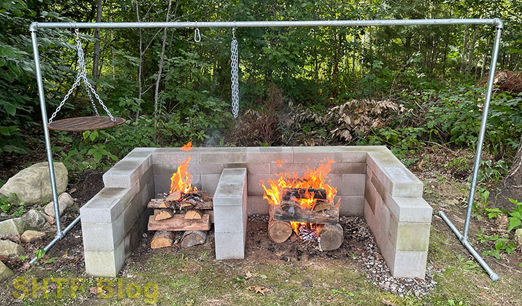 two fires burning with outdoor cooking rack
