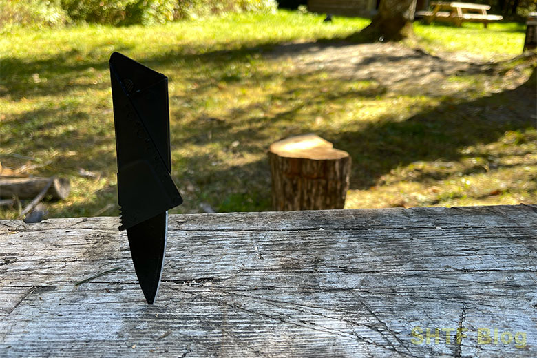 credit card knife stuck in wood